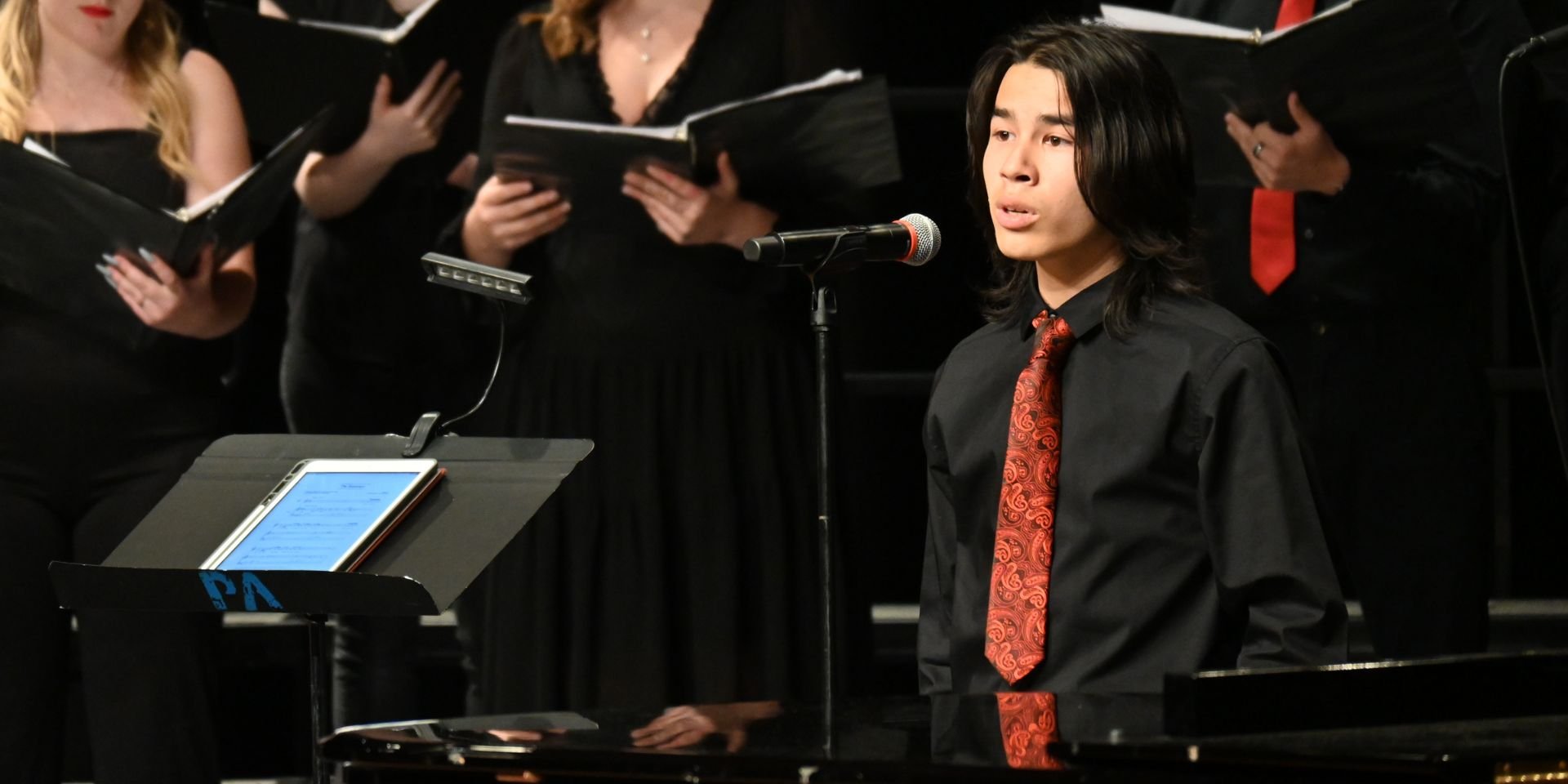 A student performs at a choral concert