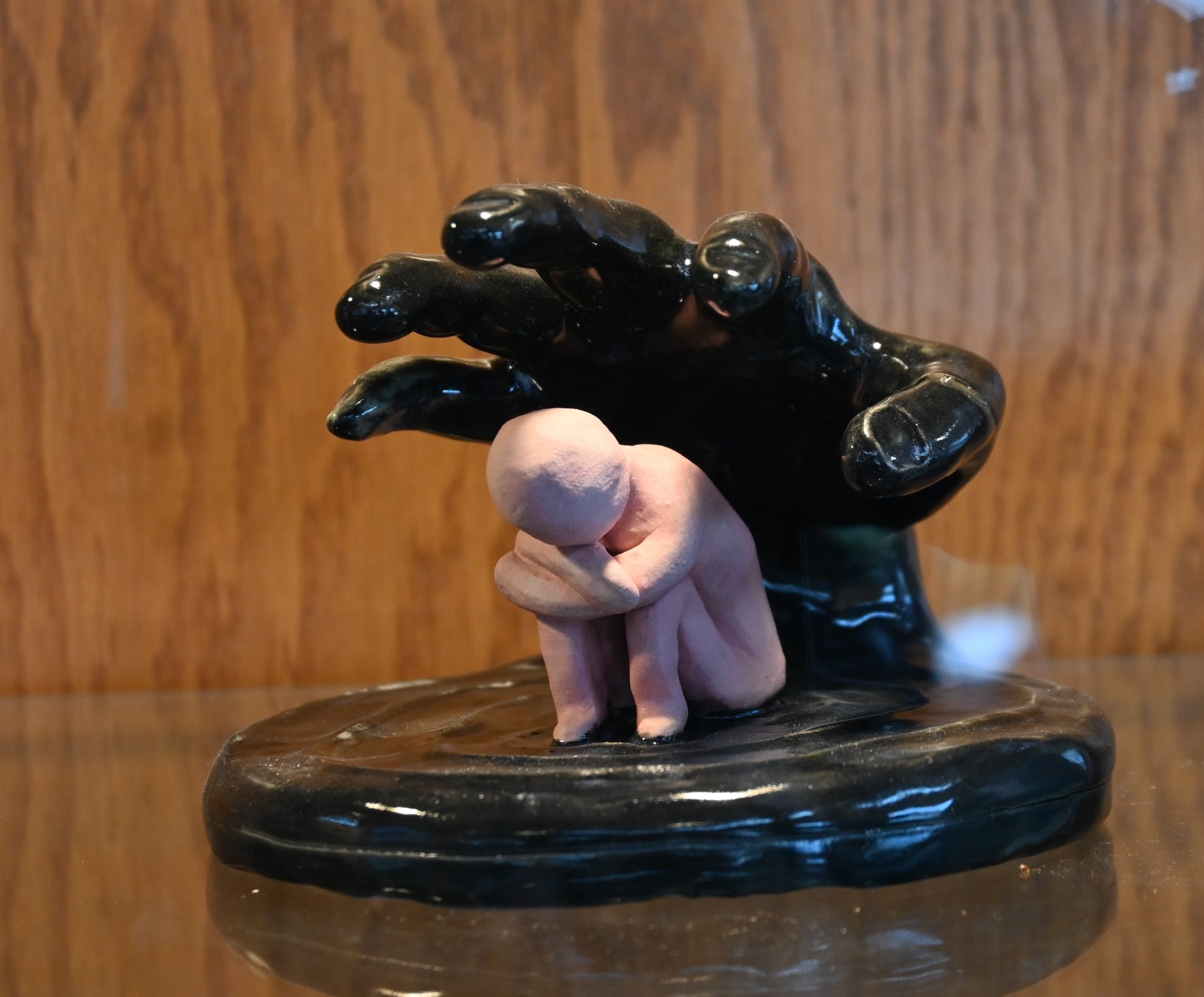 A ceramic piece of a seated figure